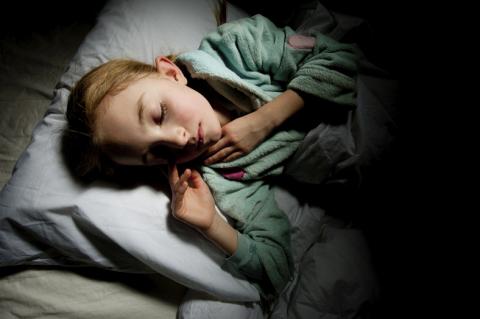 child in bed sleeping well