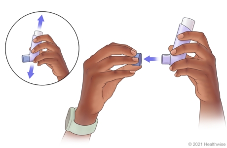 Person shaking inhaler, then taking cap off inhaler mouthpiece.