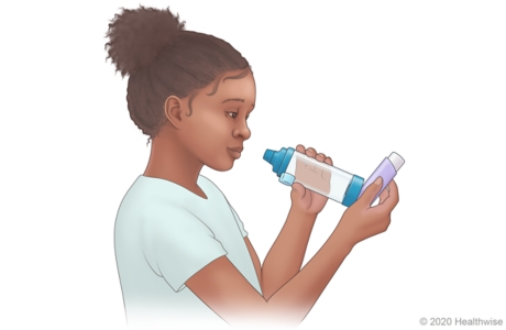 Child holding inhaler upright.