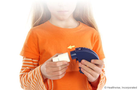 A child attaching a mouthpiece to the peak flow meter.