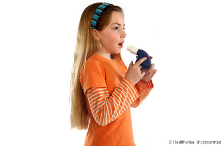 A child taking a deep breath to get ready to use the peak flow meter.