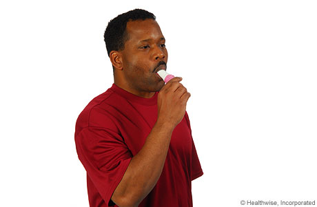 Man inhaling medicine