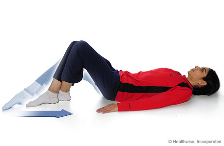 A person doing the knee-flexion-with-heel-slide exercise.