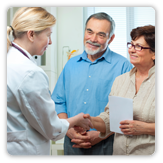 Photo of man and woman talking with doctor