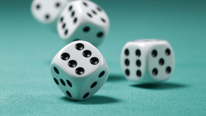 Four dice on a green surface