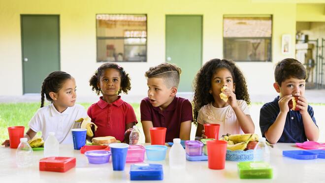 Kids eating meal at outdoor table