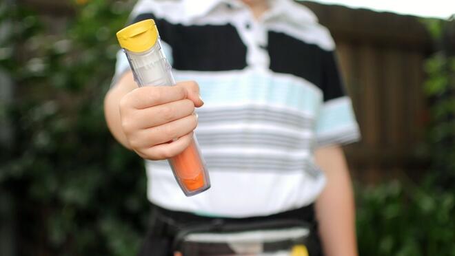 Child holding epi pen