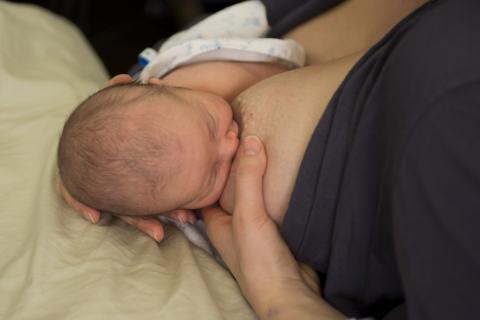 baby feeding at mother's breast