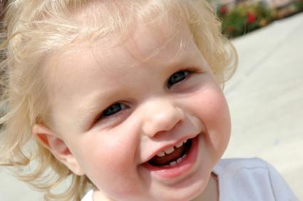 toddler with new teeth smiling