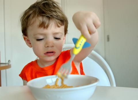 toddler eating plain spaghetti with fork