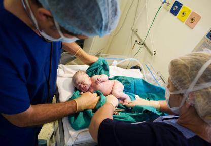 doctors examining newborn baby