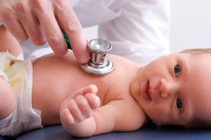 baby with doctor's stethoscope on chest