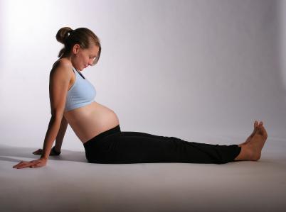 pregnant woman sitting on floor leaning back