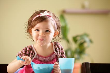toddler girl eating cereal