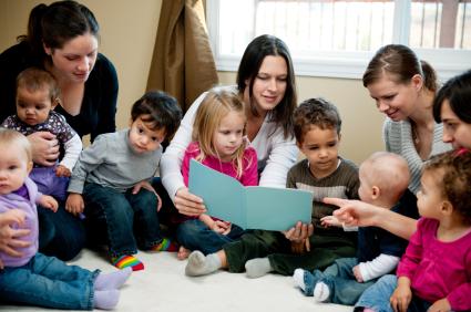 group of moms and toddlers playing and reading together