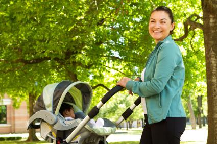 mom pushing stroller with baby sleeping inside