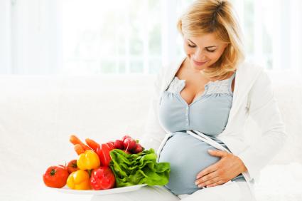 pregnant woman with plate full of vegetables