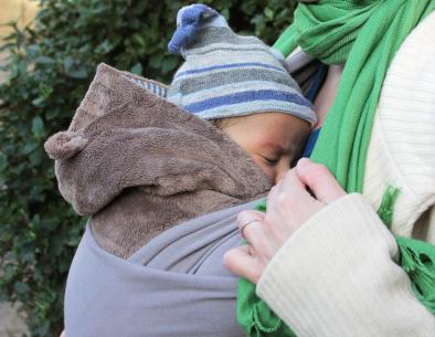 baby in baby carrier on mother's chest