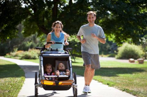 mom and dad running, mom pushing two babies in stroller