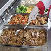 trays of food on cafeteria steam table
