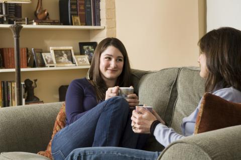 mom and teen on couch talking