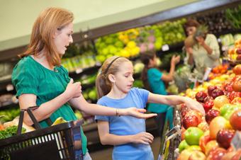 mom and daughter shopping for fruits and vegetables
