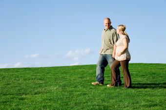 pregnant woman and man walking outdoors