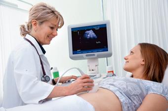 pregnant woman getting ultrasound from doctor