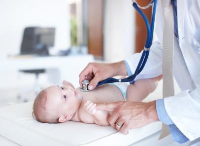 doctor putting stethoscope on baby's chest