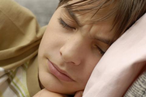 child with head on pillow sleeping soundly