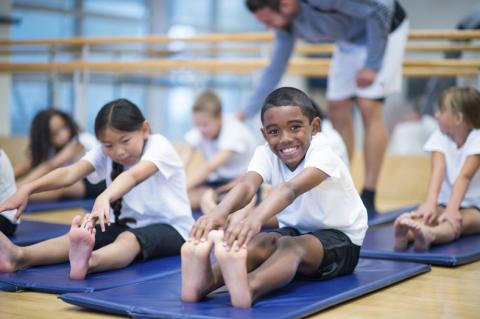 Children stretching in a gym class