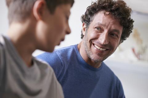 father and teen son talking and listening