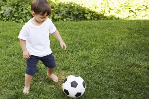 preschool boy playing with soccer ball
