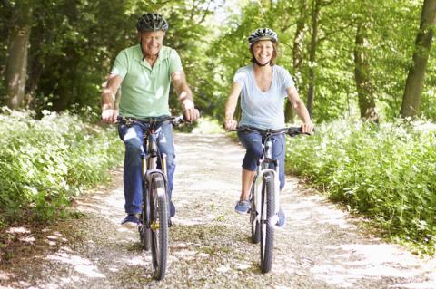 older man and woman riding bicycles